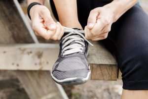 Man tying sports shoe